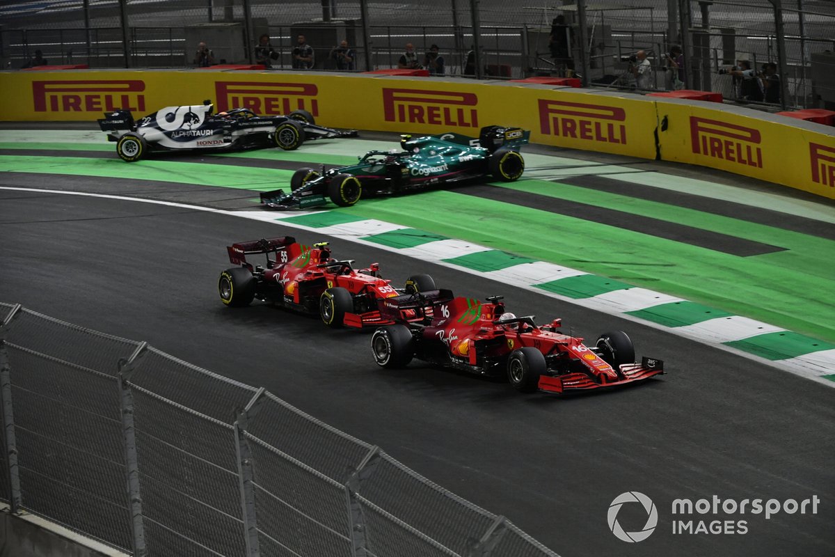 Charles Leclerc, Ferrari SF21, Carlos Sainz Jr., Ferrari SF21, as they pass Sebastian Vettel, Aston Martin AMR21, and Yuki Tsunoda, AlphaTauri AT02