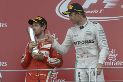 Sebastian Vettel, Ferrari with Nico Rosberg, Mercedes AMG F1