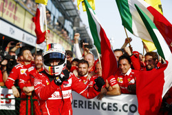 Sebastian Vettel, Ferrari, celebrates with his team after winning the race