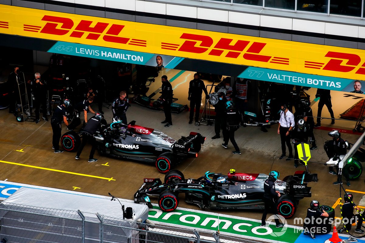 Lewis Hamilton, Mercedes W12, and Valtteri Bottas, Mercedes W12, in the pit lane