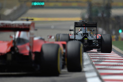 Fernando Alonso, McLaren MP4-31 leads Sebastian Vettel, Ferrari SF16-H
