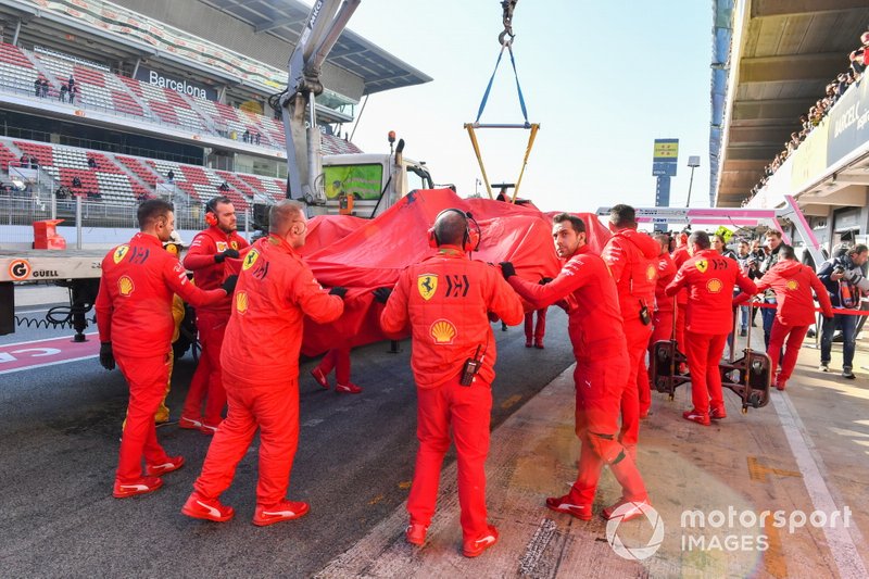 Sebastian Vettel, Ferrari, is lifted back into the garage after stopping on track