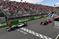Valtteri Bottas, Mercedes-AMG F1 W09 and Max Verstappen, Red Bull Racing RB14 take the chequered fla
