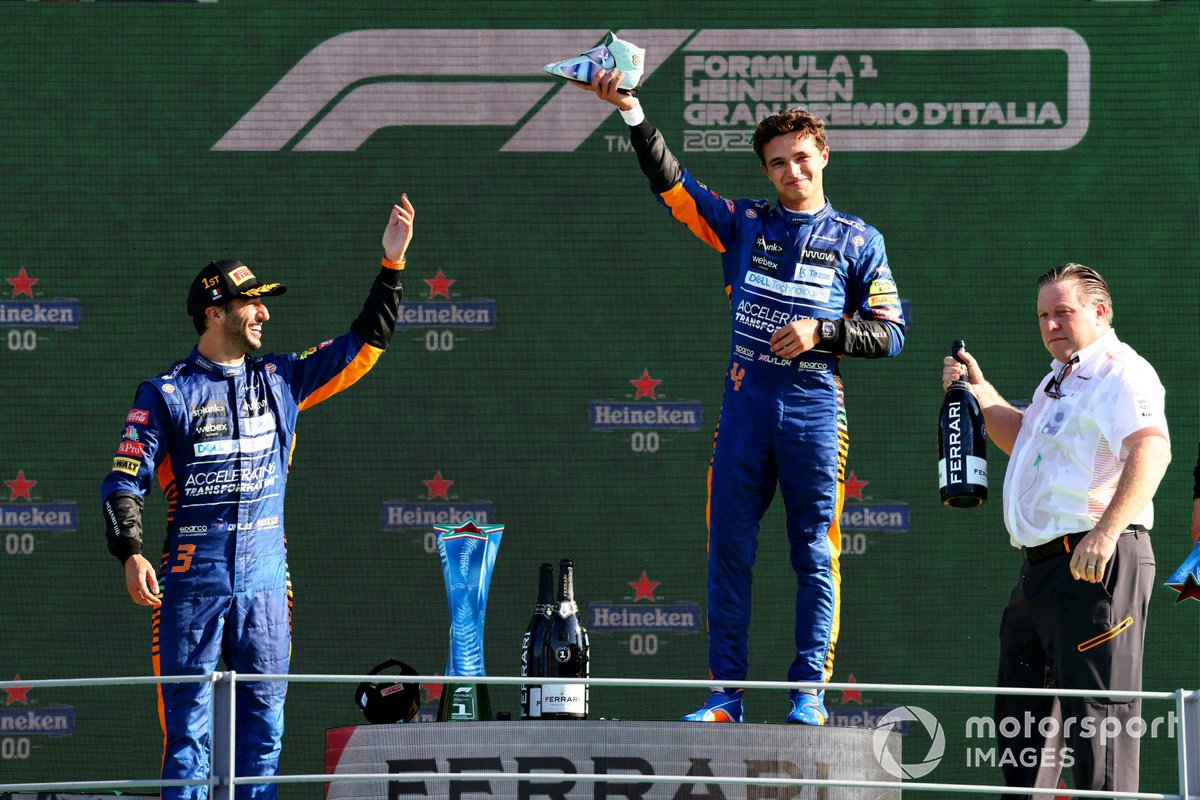 Daniel Ricciardo, McLaren, 1st position, Lando Norris, McLaren, 2nd position, and Zak Brown, CEO, McLaren Racing, celebrate on the podium with shoeys