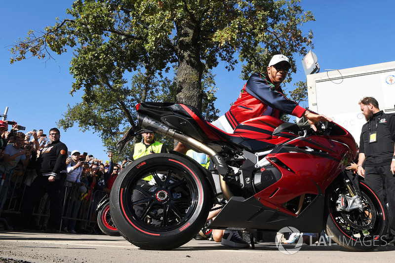 Lewis Hamilton, Mercedes AMG F1 arrives at the track on his motorbike