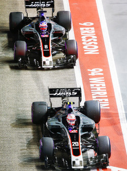 Kevin Magnussen, Haas F1 Team VF-17, Romain Grosjean, Haas F1 Team VF-17, in the pit lane