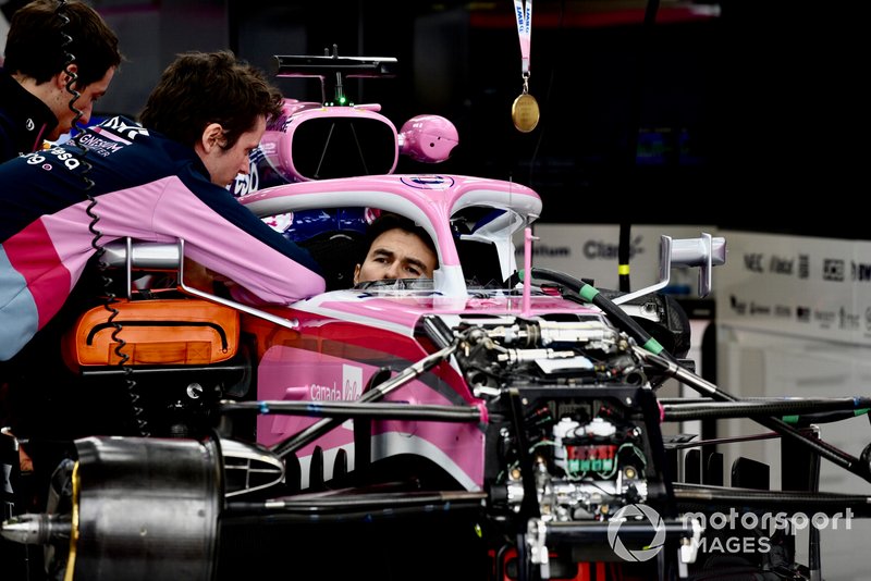 Sergio Perez, Racing Point RP19 sits in the cockpit of his car with a medal above