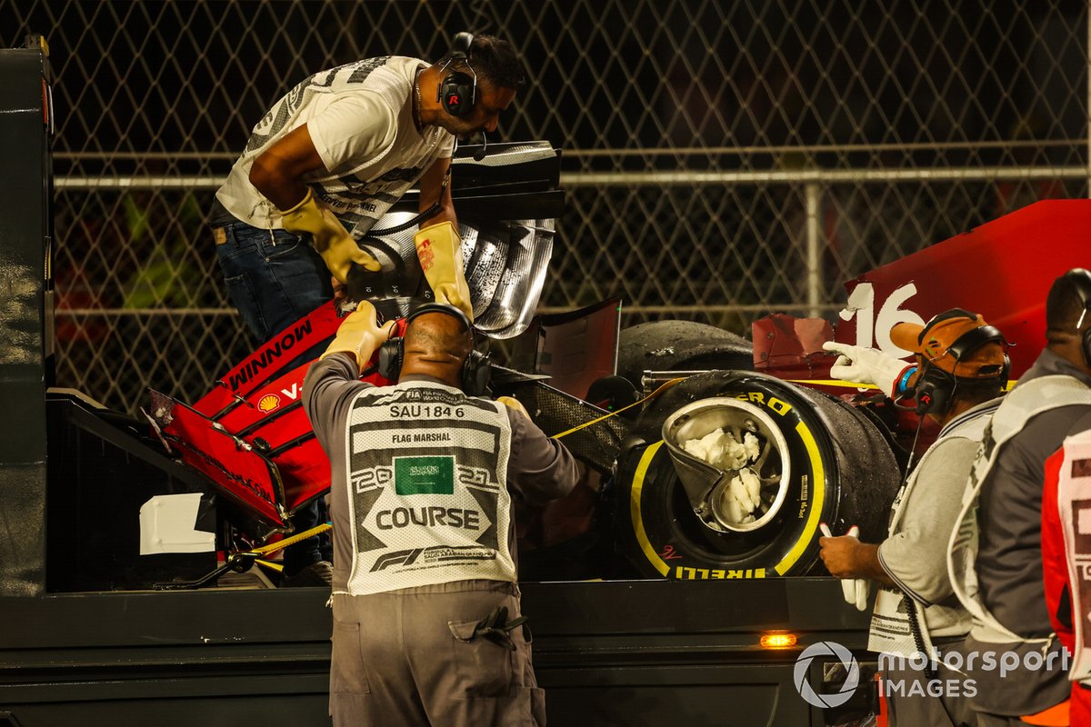 A marshal removes the fron wing from the car of Charles Leclerc, Ferrari SF21, from the circuit