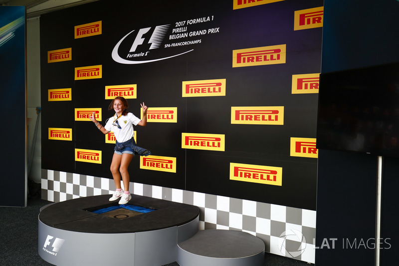 A fan tries the podium out in the F1 Fanzone
