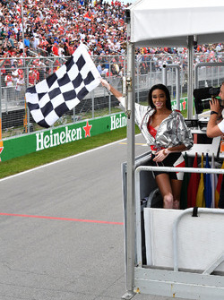 Winnnie Harlow, waves the chequered flag
