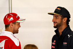 Sebastian Vettel, Scuderia Ferrari talks with Daniel Ricciardo, Red Bull Racing