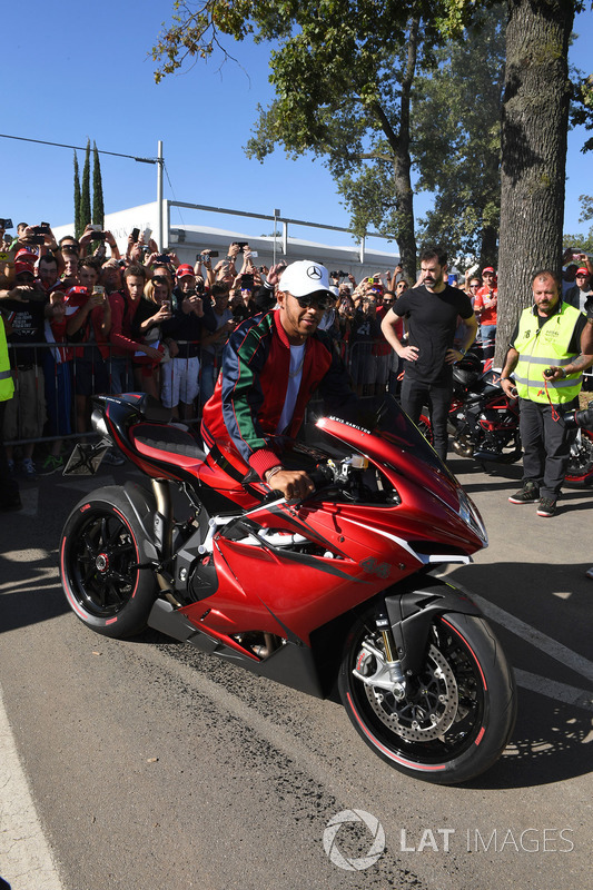 Lewis Hamilton, Mercedes AMG F1 arrives at the track on his motorbike