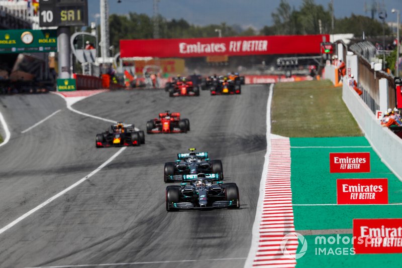 Lewis Hamilton, Mercedes AMG F1 W10, leads Valtteri Bottas, Mercedes AMG W10, Max Verstappen, Red Bull Racing RB15, Sebastian Vettel, Ferrari SF90, and the rest of the field at the restart