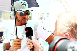 Lewis Hamilton, Mercedes AMG F1 with Johnny Herbert, Sky Sports F1 Presenter on the drivers parade