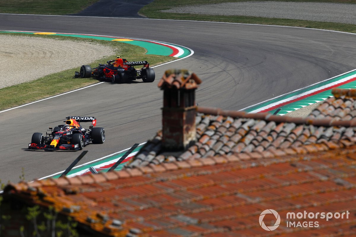 Max Verstappen, Red Bull Racing RB16B, passes Sergio Perez, Red Bull Racing RB16B, who has stopped on track