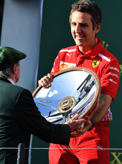 Inaki Rueda, Ferrari Race Strategist celebrates with the trophy on the podium
