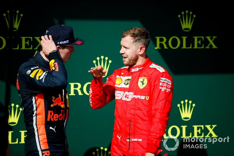 Max Verstappen, Red Bull Racing, 2nd position, talks with Sebastian Vettel, Ferrari, 3rd position, on the podium