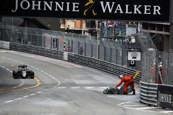 A marshal removes debris from the circuit