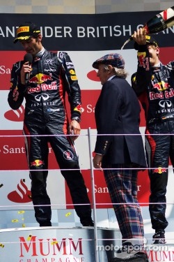 Sebastian Vettel, Red Bull Racing pours champagne on Jackie Stewart, on the podium as race winner Mark Webber, Red Bull Racing talks to the crowd
