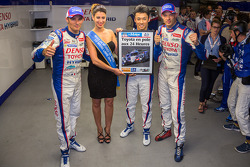 Pole winner Kazuki Nakajima celebrates with Alexander Wurz, Stéphane Sarrazin and Miss Le Mans