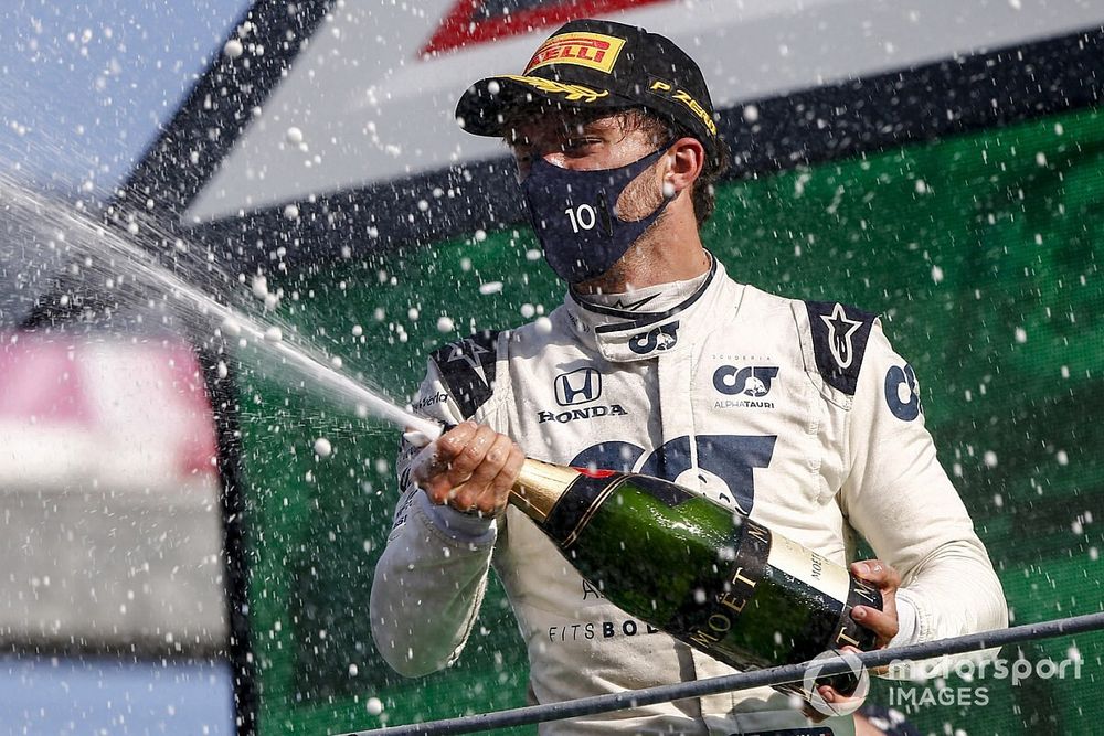 Carlos Sainz Jr., McLaren, 2nd position, and Pierre Gasly, AlphaTauri, 1st position, spray Champagne on the podium