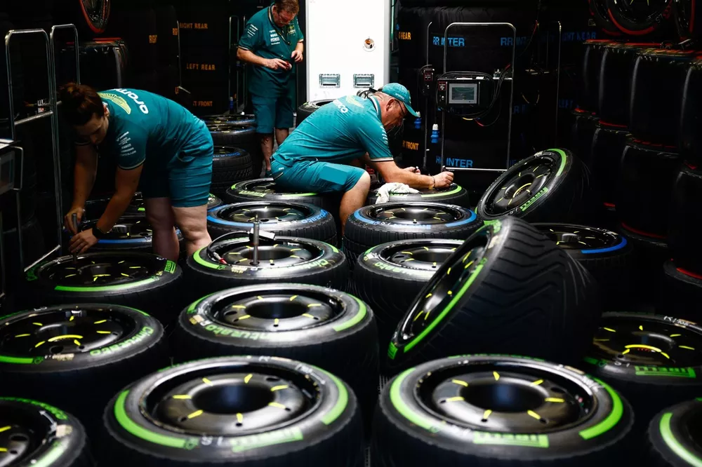 Aston Martin team members work on Pirelli tyres and wheels