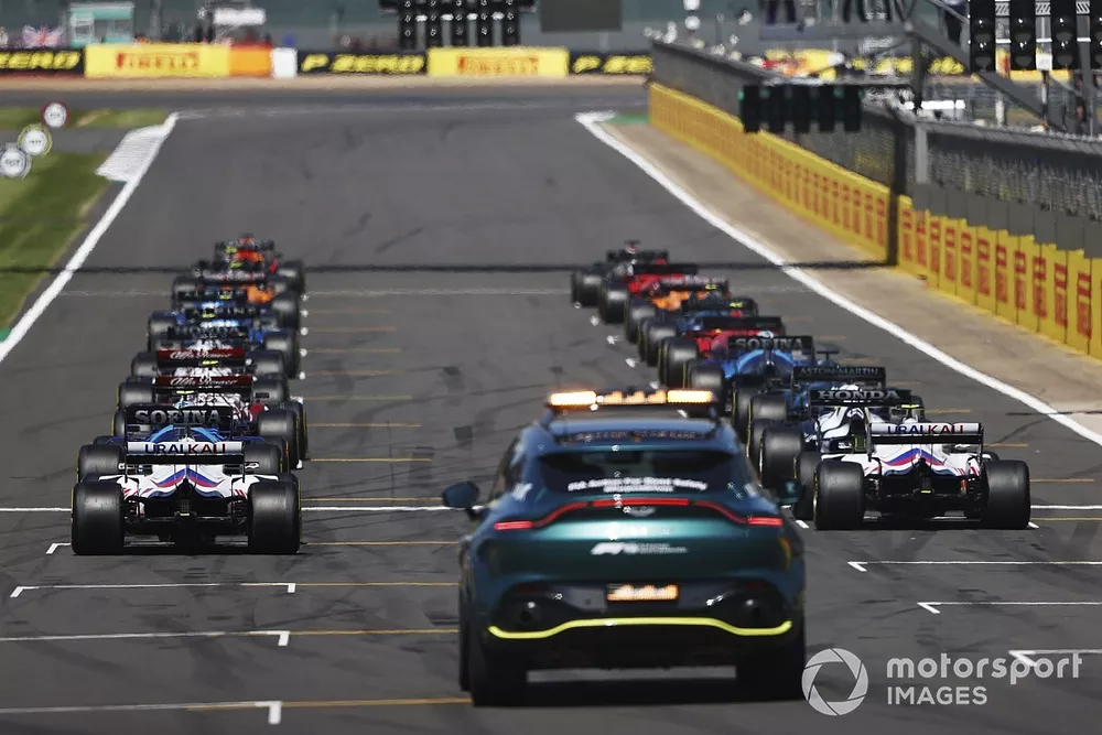 Max Verstappen, Red Bull Racing RB16B, and Lewis Hamilton, Mercedes W12, prepare to lead the drivers away at the start