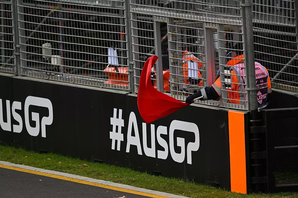 A marshal waves a red flag