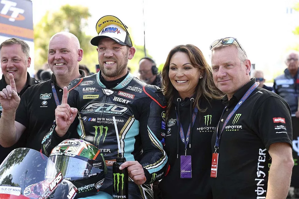 Peter Hickman celebrates winning the first Superstock TT with FHO Racing BMW boss, Faye Ho and his team