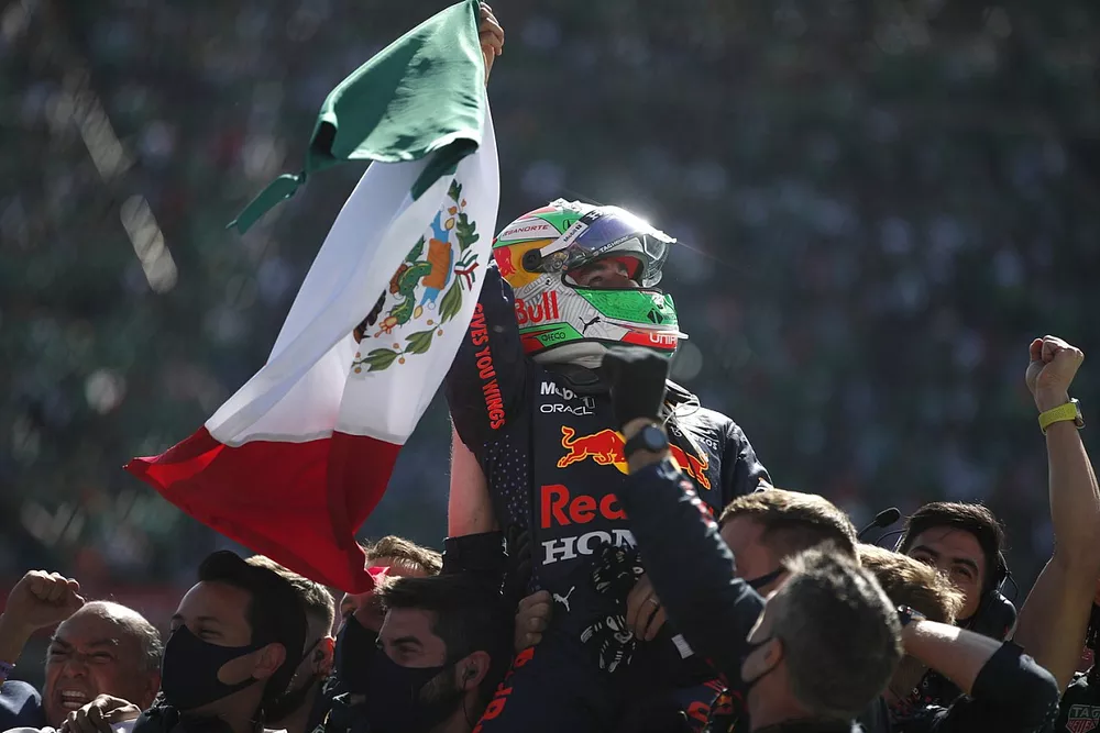 Sergio Perez, Red Bull Racing, 3rd position, celebrates in Parc Ferme with his team