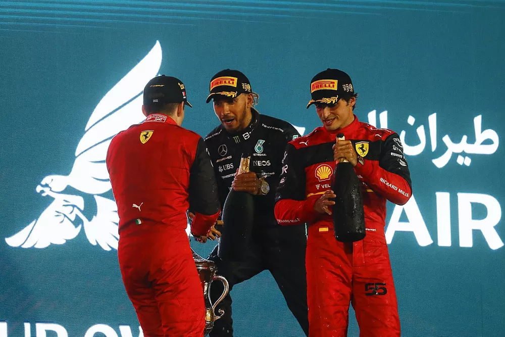 Carlos Sainz Jr., Ferrari, 2nd position, Charles Leclerc, Ferrari, 1st position, Lewis Hamilton, Mercedes-AMG, 3rd position, celebrate on the podium