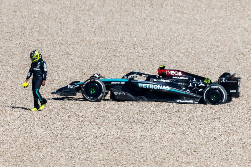 Lewis Hamilton, Mercedes F1 W15, walks away from his car after retiring in the gravel