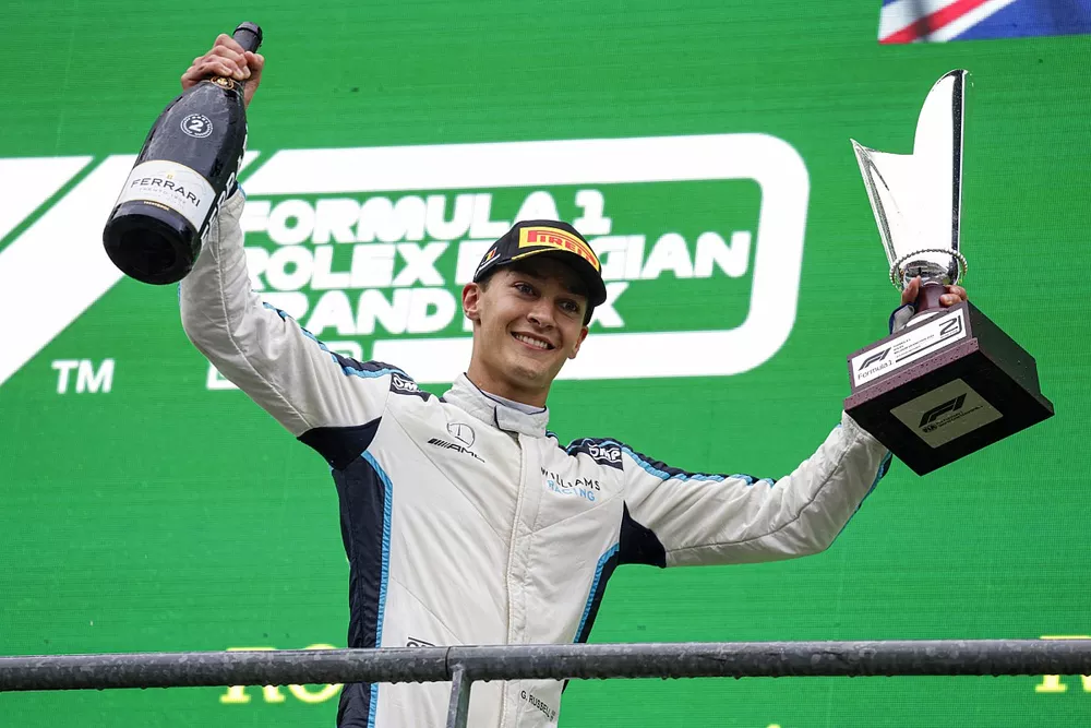 George Russell, Williams, 2nd position, with his trophy and Champagne on the podium