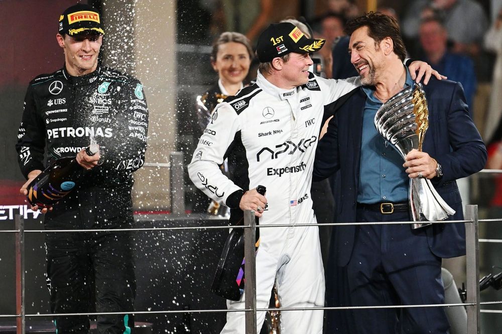George Russell, Mercedes-AMG F1 Team, Brad Pitt and Javier Bardem film a scene for the F1 movie on the podium

