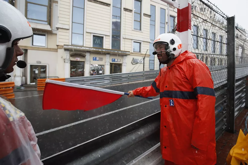 A marshal waves a red flag