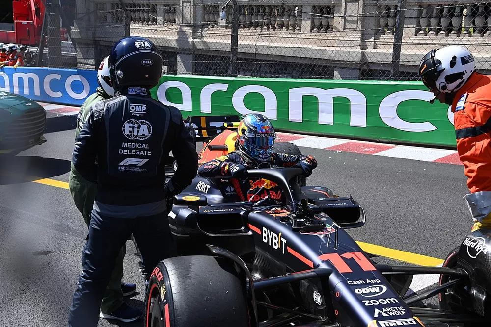 The FIA Medical Delegate speaks with Sergio Perez, Red Bull Racing RB19, after a crash in FP1