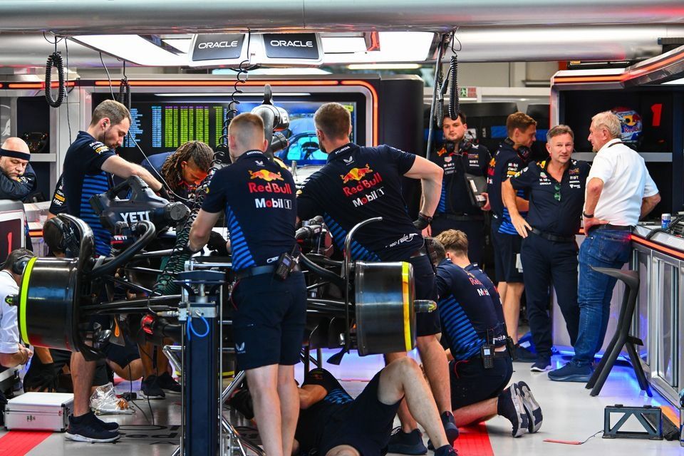 Christian Horner, Team Principal, Red Bull Racing, Helmut Marko, Consultant, Red Bull Racing, talk in the garage as mechanics work on the car of Max Verstappen, Red Bull Racing RB20