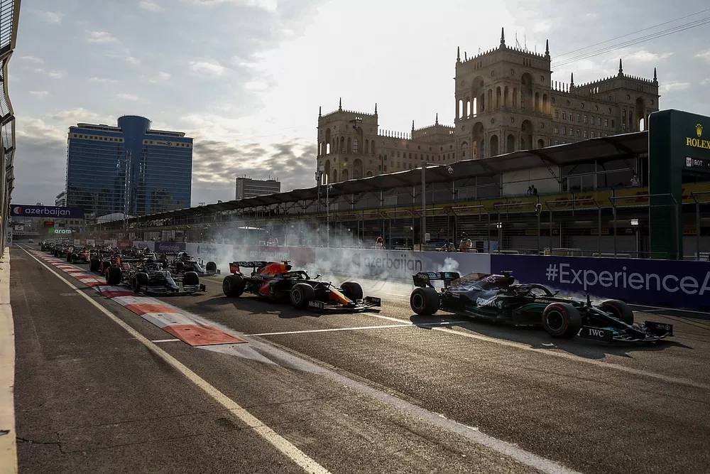 Lewis Hamilton, Mercedes W12 runs wide from Sergio Perez, Red Bull Racing RB16B at the restart of the race