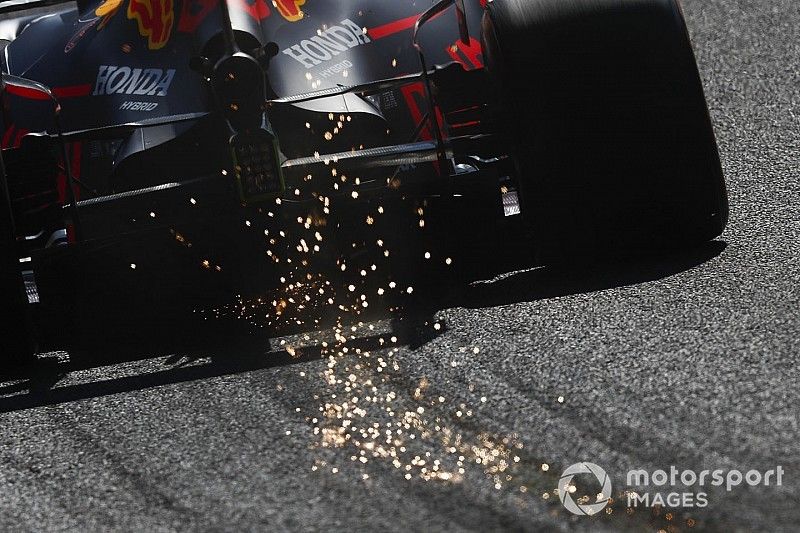 Sparks fly from the rear of Max Verstappen, Red Bull Racing RB15