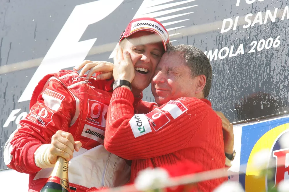 Michael Schumacher, Ferrari 248F1, 1st position, and Jean Todt, podium