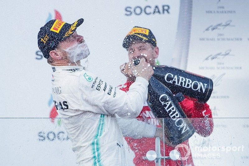 Valtteri Bottas, Mercedes AMG F1, 1st position, sprays the victory Champagne into his face and Sebastian Vettel, Ferrari, 3rd position, joins in