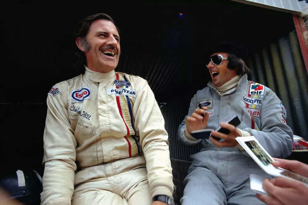 Graham Hill shares a joke with Jackie Stewart during practice
