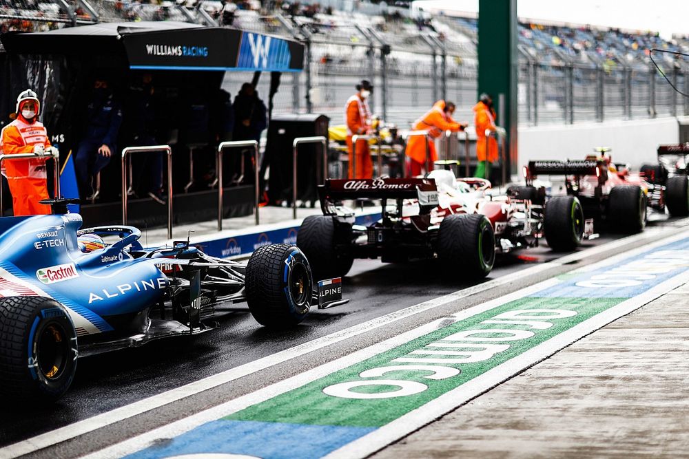 Carlos Sainz Jr., Ferrari SF21, Antonio Giovinazzi, Alfa Romeo Racing C41, and Fernando Alonso, Alpine A521, in the queue to leave the pits