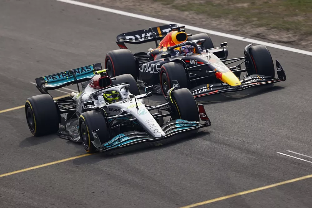 Lewis Hamilton, Mercedes W13, battles with Max Verstappen, Red Bull Racing RB18, for the lead after the restart