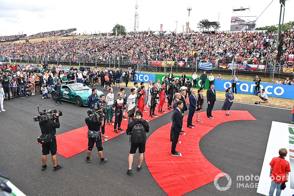 The drivers and dignitaries on the grid prior to the start for the national anthem