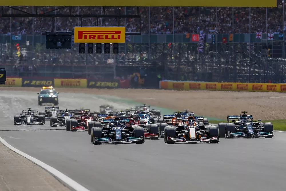 Max Verstappen, Red Bull Racing RB16B, and Lewis Hamilton, Mercedes W12, lead the field away at the start