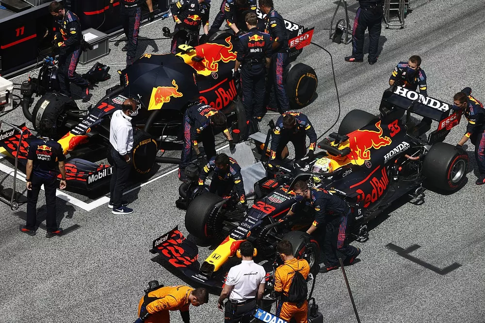 Max Verstappen, Red Bull Racing RB16B, passes Sergio Perez, Red Bull Racing RB16B, on the grid