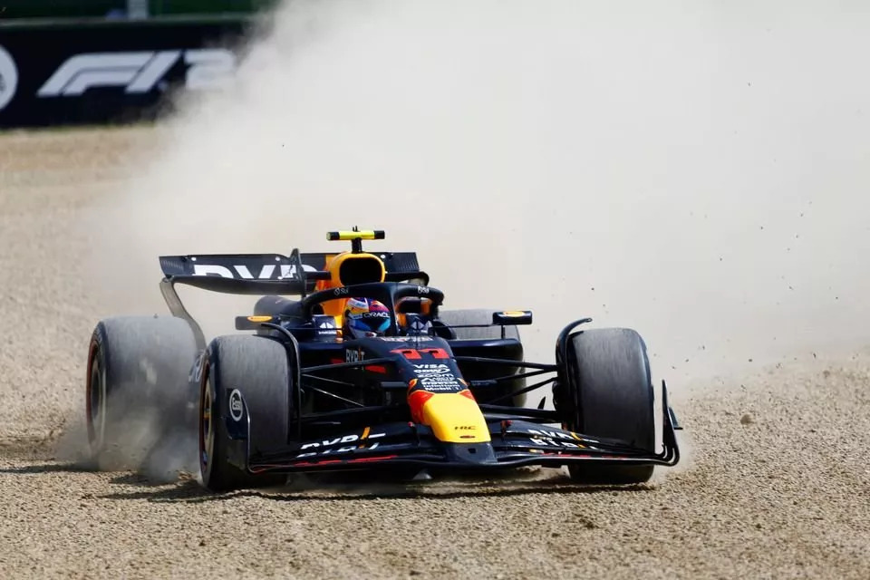 Sergio Perez, Red Bull Racing RB20, drives off the track into the gravel