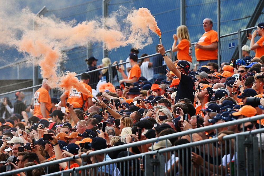 Fans in the grandstand set off flares