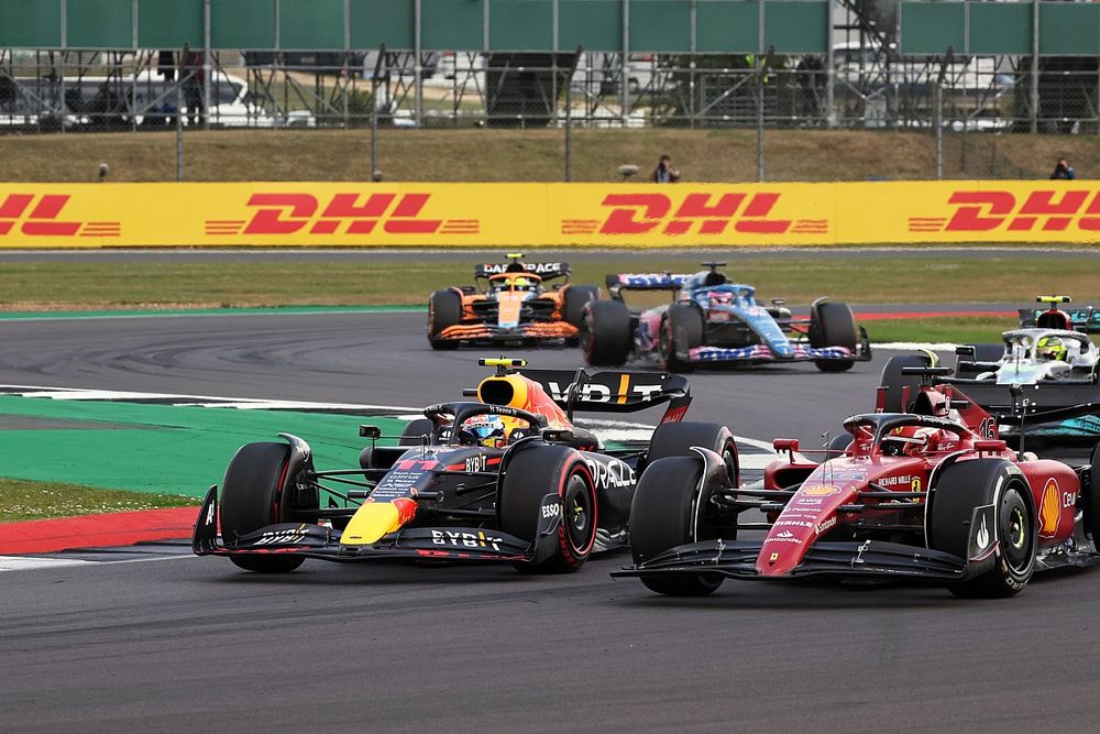 Charles Leclerc, Ferrari F1-75, battles with Sergio Perez, Red Bull Racing RB18